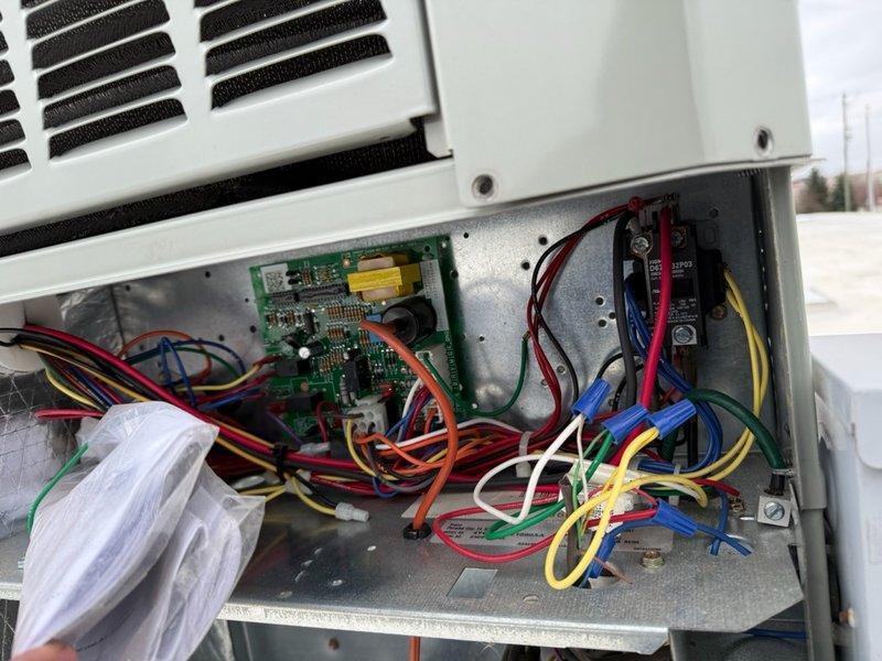 Completed spring preventive maintenance on commercial HVAC system per contract agreement. Performed comprehensive inspection of outdoor condensing unit, verifying electrical connections, control board operation, and measuring operating amperage at 9.3 amps. Documented equipment specifications and filter requirements, photographing control panel wiring and electrical components for service records.