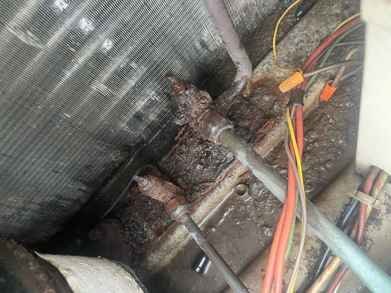 Completed comprehensive spring preventive maintenance inspection on commercial HVAC system per prepaid maintenance agreement. Performed complete cooling season checklist including refrigerant level verification, electrical connections inspection, and condenser unit evaluation on outdoor heat pump unit. Documented significant corrosion on indoor copper refrigerant lines and connection points requiring monitoring, along with dust accumulation on mechanical components in confined installation space. Updated equipment information and filter specifications for maintenance records, flagging necessary changes to filter list for future service coordination.