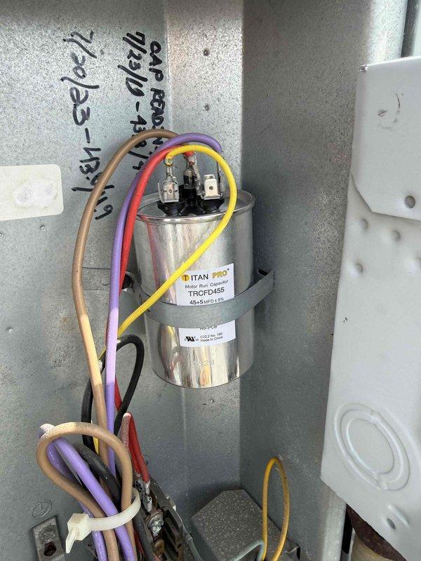 Replaced failed dual-run capacitor (35+5 MFD, 440VAC) on commercial HVAC unit with new TITAN PRO TRCFD455 model. Verified proper wire connections to compressor and fan motor terminals, secured unit with mounting strap, and confirmed system operation.