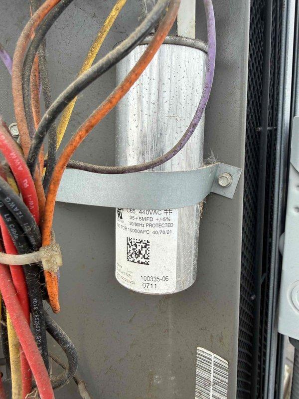 Replaced failed dual-run capacitor (35+5 MFD, 440VAC) on commercial HVAC unit with new TITAN PRO TRCFD455 model. Verified proper wire connections to compressor and fan motor terminals, secured unit with mounting strap, and confirmed system operation.