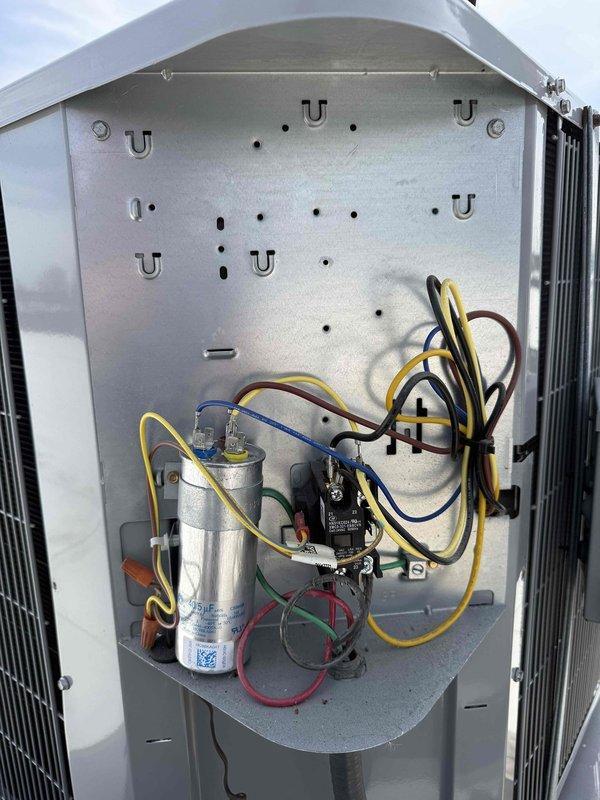 Completed spring preventive maintenance on commercial rooftop HVAC unit per contract specifications. Performed comprehensive system inspection including electrical testing with clamp meter showing 57.1 amp compressor draw, verified capacitor operation and connections, inspected condenser coil condition, and documented equipment specifications and filter information. Updated maintenance checklist and photographed unit components for service records.
