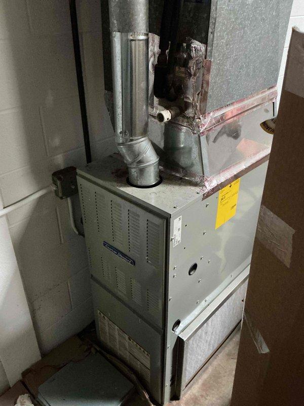 Completed scheduled commercial HVAC maintenance on furnace unit that was previously missed during initial service window. Performed comprehensive system inspection, replaced air filter, and verified all mechanical and electrical components including capacitor operation. Applied service date stickers to equipment per protocol and documented significant water damage and deterioration observed on wooden framing above furnace unit, which may require future attention to prevent further structural compromise or potential safety concerns.