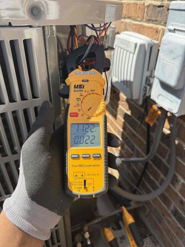 Performed comprehensive clean and check maintenance on mini-split air conditioning system per comfort plan agreement. Conducted diagnostic testing using digital thermometer measuring supply air temperature at 59.4°F and clamp meter recording electrical readings of 112.2 volts and 0.022 amps, confirming system operating within normal parameters. Completed full inspection of outdoor unit including condenser coils, electrical connections, and refrigerant lines with all components found in proper working condition.