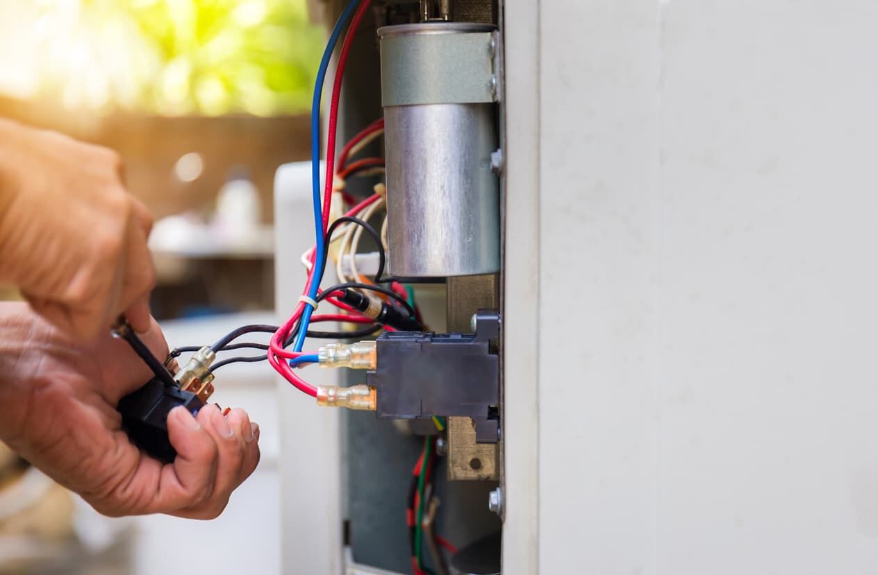 HVAC technician repairing a residential AC unit