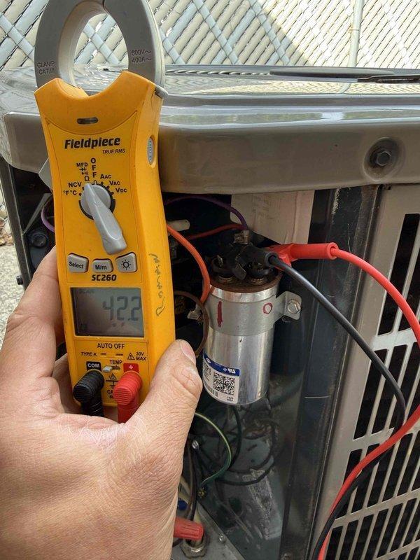 Completed comprehensive tune-up service on residential HVAC system. Performed electrical diagnostics using clamp meter, verified voltage readings at 422V, and inspected capacitor connections and wiring integrity at outdoor condensing unit. Removed and inspected heavily soiled return air filter showing significant dust accumulation, affecting system airflow. Evaluated indoor furnace components including burner assembly and gas valve connections. System operational following service; customer educated on proper filter maintenance schedule to maintain optimal performance and efficiency.