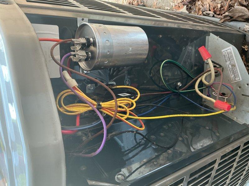 Replaced defective 45/5 MFD dual-run capacitor under warranty on outdoor HVAC unit. Disconnected all electrical connections from failed capacitor, removed old component, installed new capacitor with proper wire terminations to compressor and condenser fan motor circuits, and verified secure mounting and electrical connections before restoring system operation.