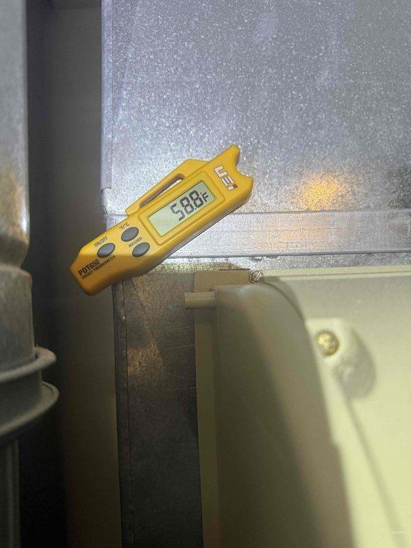 Responded to no cooling complaint on residential air conditioning system. Upon arrival, performed system diagnostics and temperature measurements. Found supply air temperature reading 58.8°F at evaporator coil. Inspected electrical components including capacitor and associated wiring connections. All equipment information documented and photographed for service records.