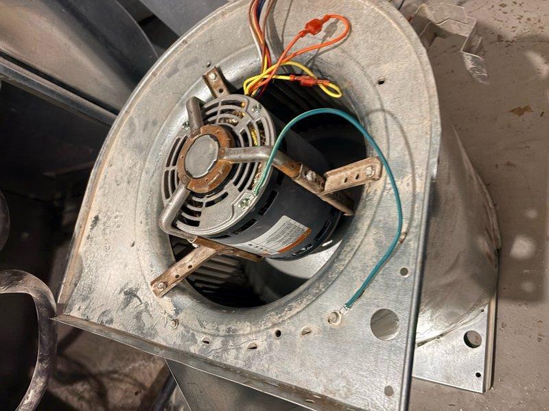 Responded to callback for no heat and burnt smell complaint following recent blower motor replacement on 9-year-old HVAC system. Upon arrival, inspected blower motor assembly and verified proper installation, mounting, and electrical connections. All wire terminations secure with appropriate color-coded wiring including ground wire properly routed. Blower motor operational within housing with no signs of overheating or electrical failure. Inspected evaporator coil and heat exchanger, noting moderate dust accumulation and surface contamination on fins. System tested and confirmed heating operation restored with no abnormal odors detected during runtime.