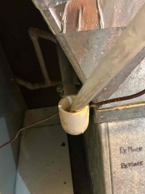 Responded to emergency service call for leaking Aprilaire whole-home humidifier in residential mechanical room. Upon arrival, found humidifier and furnace had been shut off by customer due to active water leak. Performed diagnostic inspection of humidifier unit, including examination of water supply line connections, solenoid valve, drain system, and humidifier pad assembly. Identified source of leak and assessed condition of mounting, ductwork connections, and associated plumbing components. Documented existing equipment configuration with humidifier mounted to HVAC system alongside Rheem water heater in basement utility space. Photographed installation showing flexible ductwork, metallic insulation, and component connections for service records. Evaluated humidifier water panel condition and drainage pathway. Provided customer with repair options and recommendations for resolving leak issue to restore safe humidification operation.