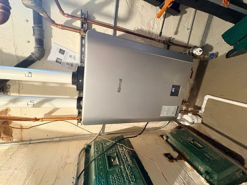 Responded to no hot water call on recently installed Rinnai tankless water heater. Upon arrival, inspected unit and found reset button had been tripped on the control panel. Reset the system and verified proper operation of all connections, copper piping, shut-off valves, and digital display panel. Tested unit to confirm hot water restoration and normal function.