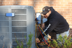 man fixing a central ac unit