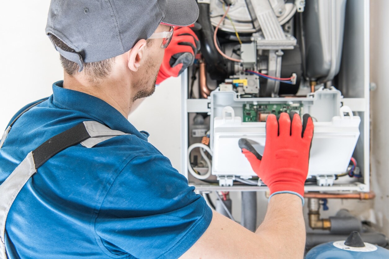 HVAC technician performing heating replacement in client home