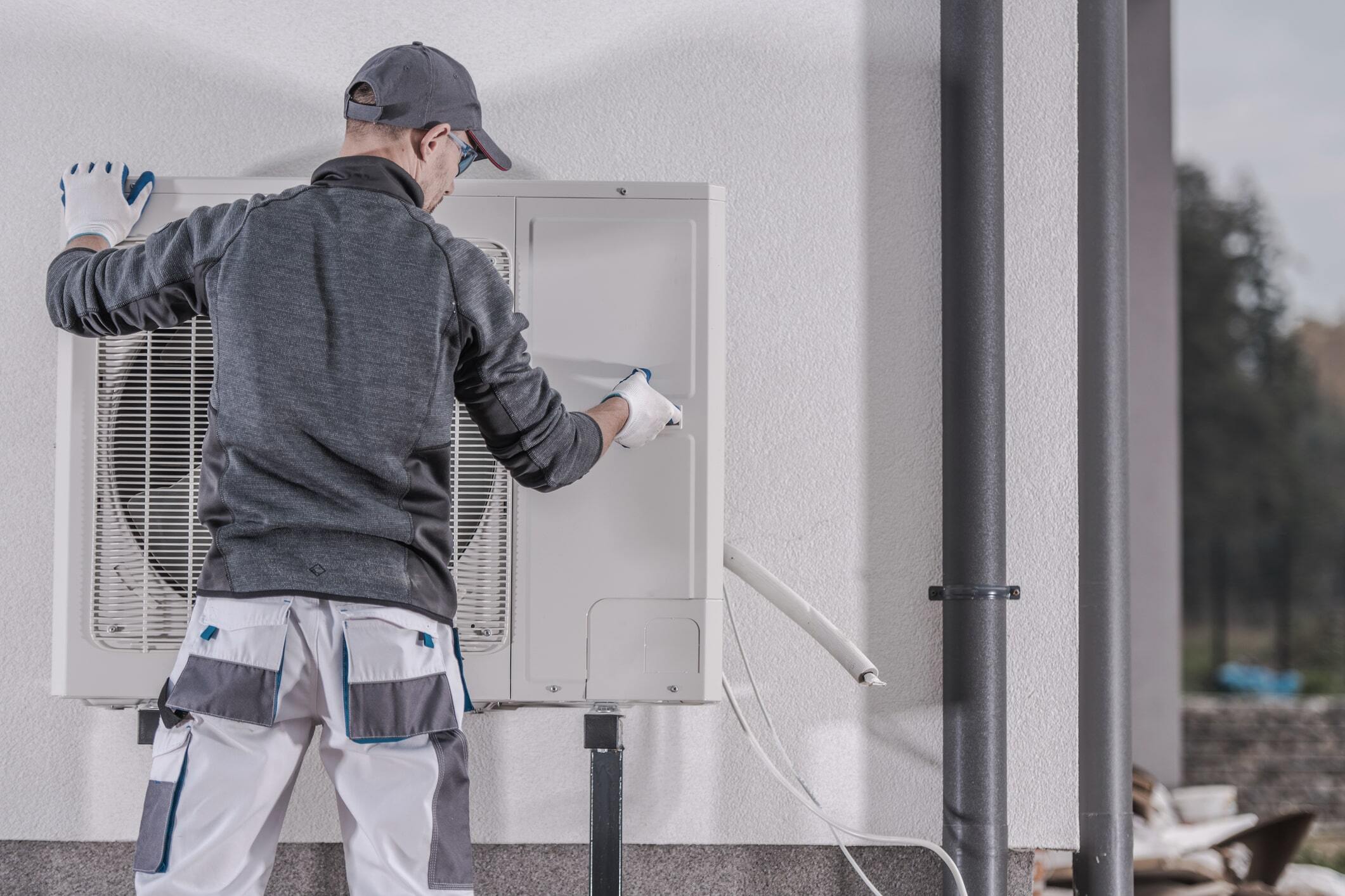 Technician repairs a residential heat pump