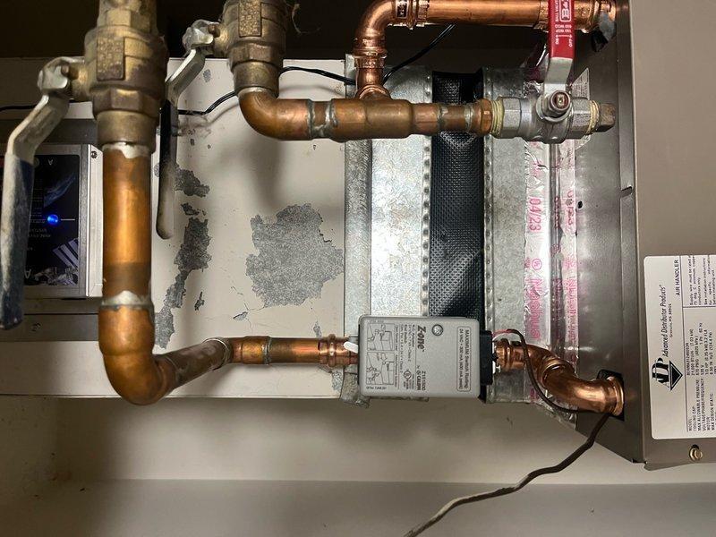 Completed full HVAC system replacement including disconnection and proper disposal of existing air handler with hydronic coil from mechanical closet and removal of existing A/C condenser per EPA guidelines. Installed new ADP 1.5-2.0 ton air handler with hydronic coil in mechanical closet, connecting to existing supply air ductwork, return air ductwork, and electrical service. Fabricated and installed necessary sheet metal transitions to ensure proper fitment of new equipment. Installed new Lennox 13 SEER2 ML13KC1-024-230 2.0 ton condensing unit on roof in same location as previous unit. Flushed existing copper line-set and connected to new system. Installed Air Scrubber, EZ trap, and surge protector for enhanced system protection and air quality. Replaced existing thermostat with new Honeywell T4 programmable unit. Performed complete system startup, testing, and final adjustments to ensure optimal performance and efficiency. All work completed to manufacturer specifications with 10-yea
