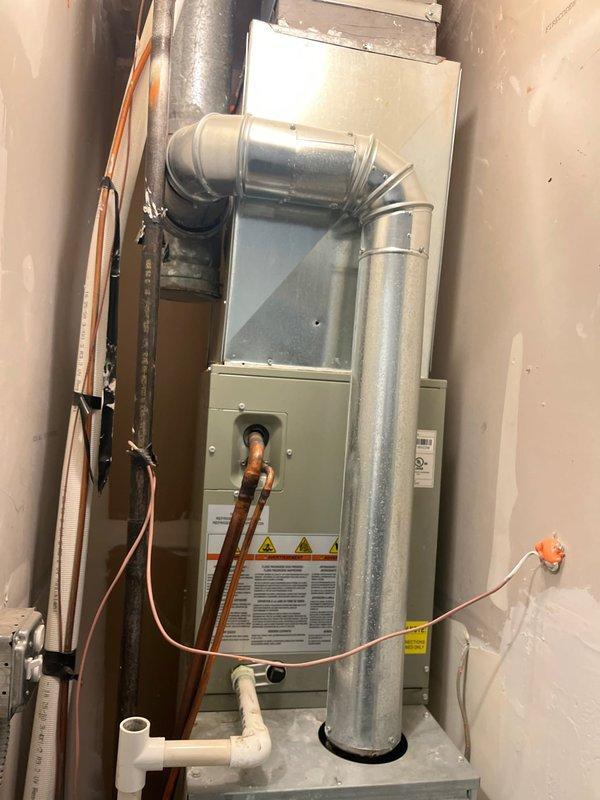 Conducted comprehensive AC replacement estimate for residential system that ceased operation during previous cooling season. Evaluated existing Ameristar furnace/air handler installation with associated refrigerant lines, ductwork, and condensate drainage system in basement utility area. Customer elected to defer repairs at end of last season and is now pursuing complete system replacement options. Documented current equipment configuration including copper refrigerant piping, PVC condensate lines with emergency float switch, electrical conduit, and silver galvanized supply ductwork for accurate replacement specifications.