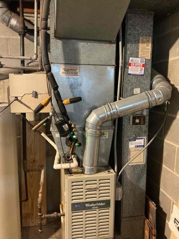 Responded to no cooling complaint on residential WeatherMaker 9200 system with ecobee3 lite thermostat showing 8-degree temperature differential. Performed diagnostic evaluation of furnace and air handler unit in basement mechanical room, inspected ductwork connections and plenum assembly. Documented heavily soiled 16x25x1 air filter with significant particulate buildup restricting airflow, which was identified as primary cause of inadequate cooling performance and reduced system efficiency.