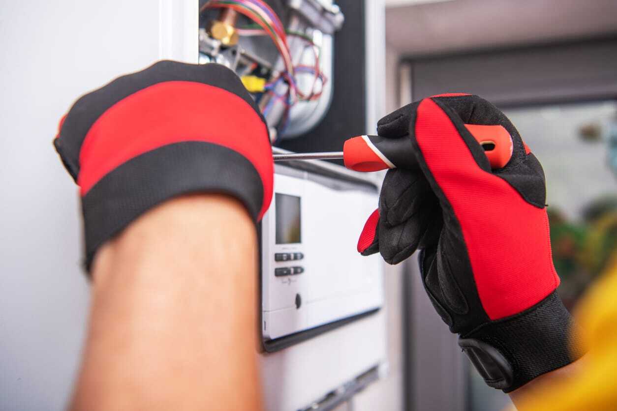 HVAC technician performing heating repair in a client's house