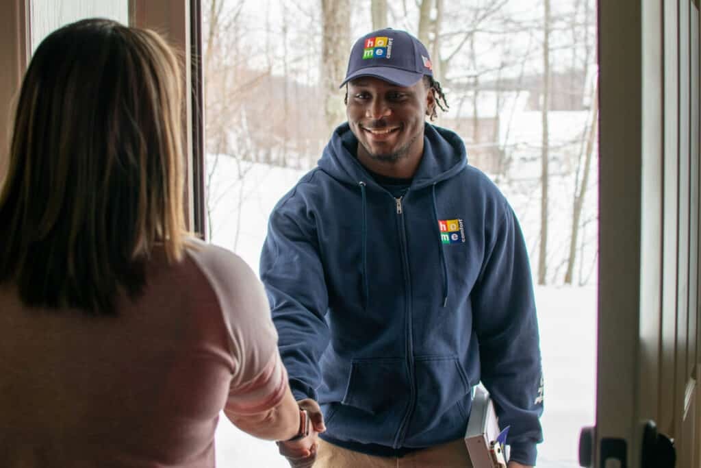 Home Comfort technician shaking the hand of a homeowner during a service call
